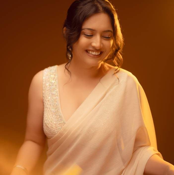 Archie laughing in an ivory sari